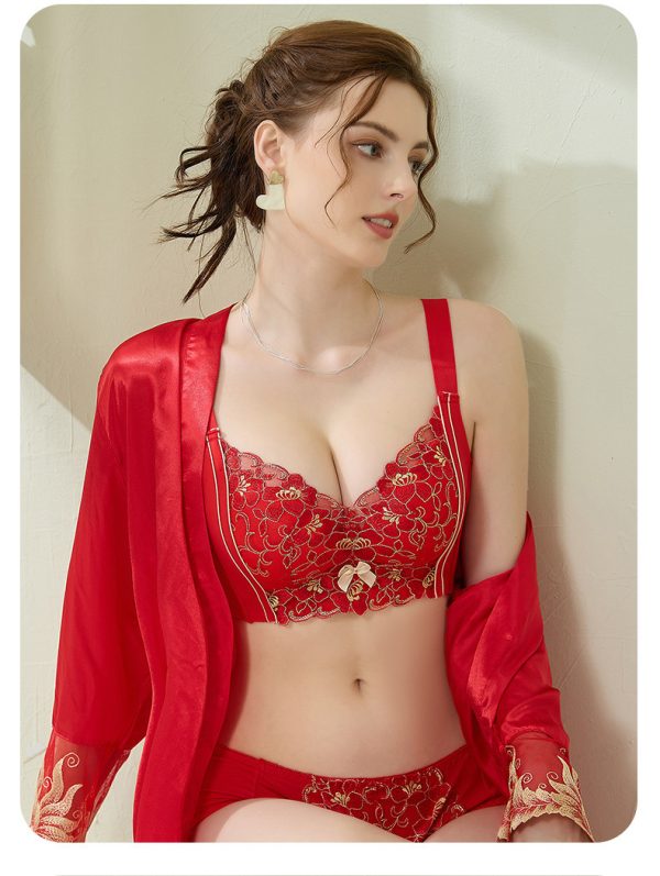 A model wearing the vibrant Bright Red luxury lace embroidered bra set with a matching red satin robe, highlighting the wire-free push-up 3/4 cup support design,